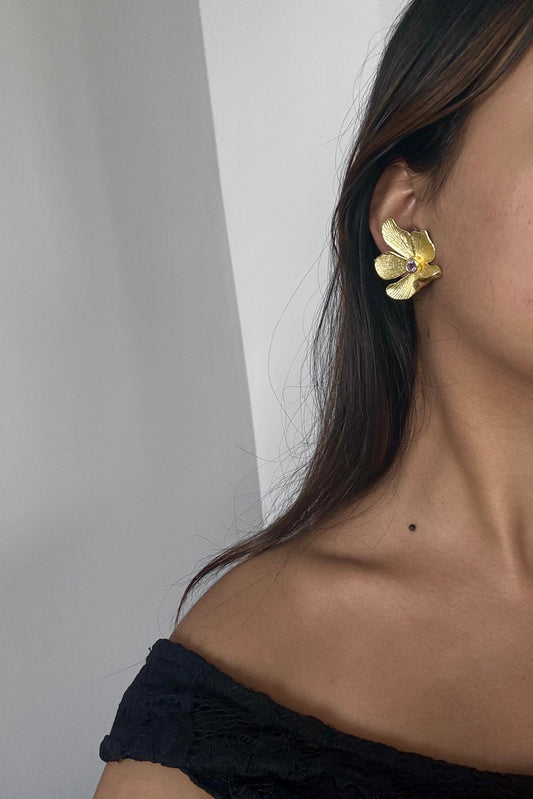 Earrings shaped like blooming orchids, crafted with feminine grace and bold edges from shopbaari.com | baari jwellery