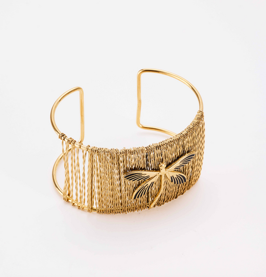 Gold bracelet with a butterfly design on a white background